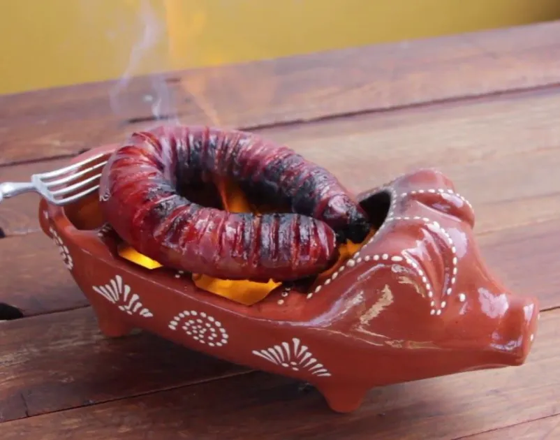 Flaming chouriço assado at the table