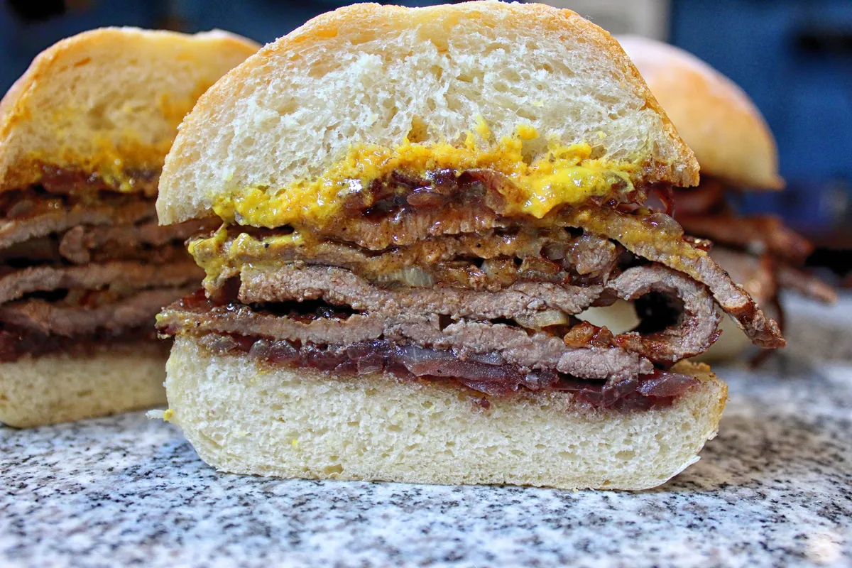 Prego beef sandwich on a soft roll