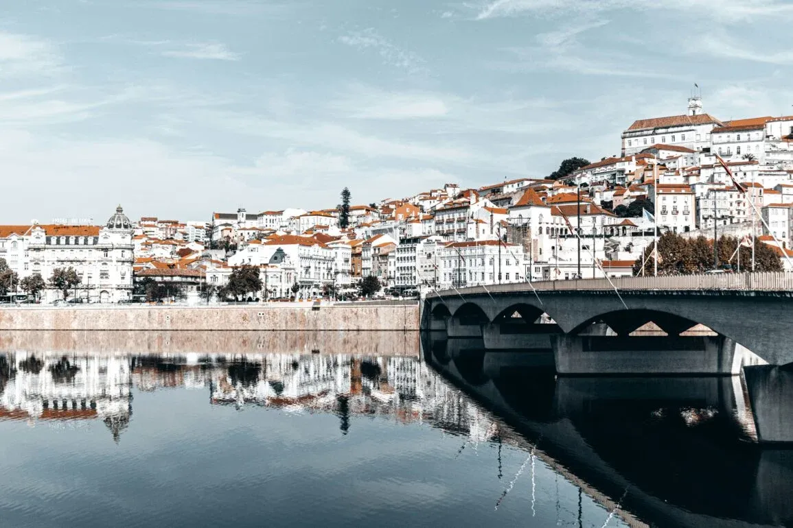 View of the historic University of Coimbra perched on a hill overlooking the Mondego river