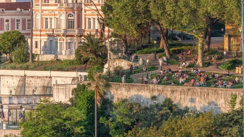 Locals relaxing in the grass at Jardim do Torel