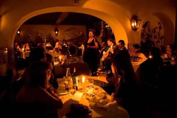 Musicians performing traditional Fado in a small dark bar