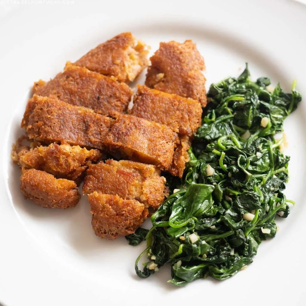 Alheira sausage served with garlicky spinach